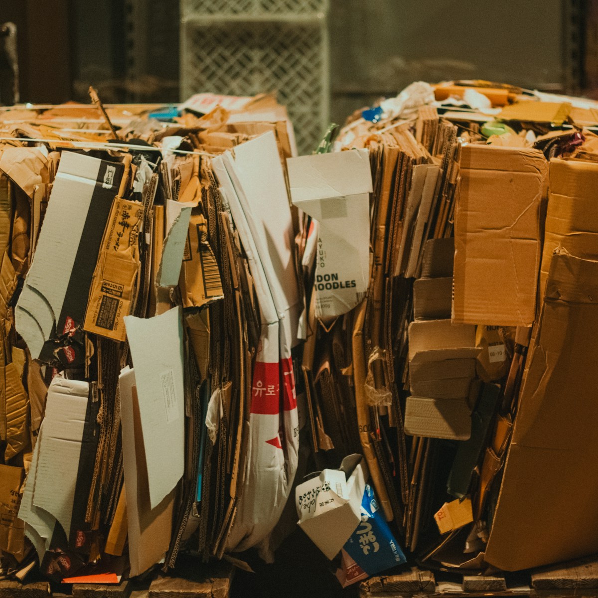 A pile of cardboard sitting on top of a wooden floor